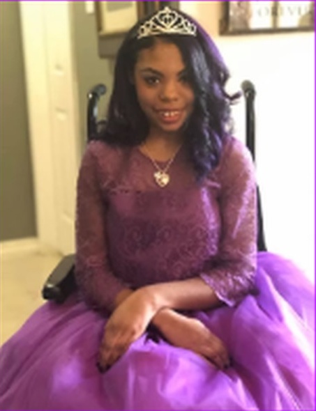 Keki wearing her purple dress and tiara